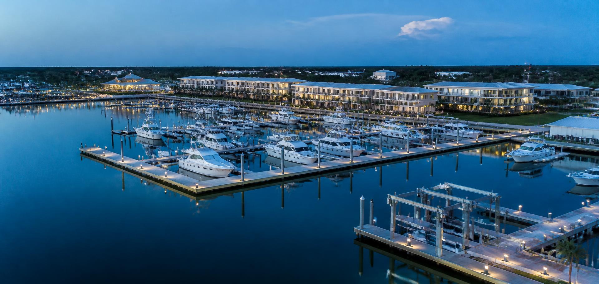 Marina at blue hour with docked boats and lifts