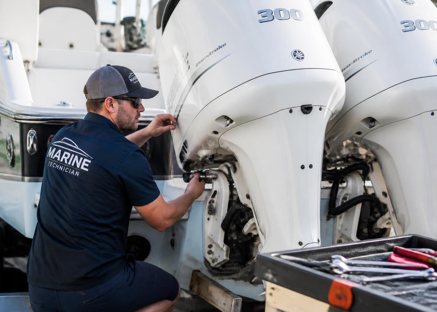 Marine technician servicing outboard engines